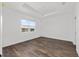 Bright bedroom with modern wood flooring and a large window with a view at 10347 Sw 99Th Ln, Ocala, FL 34481