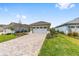 Charming single-story home featuring a paved driveway and a 2-car garage with a lush green lawn at 10347 Sw 99Th Ln, Ocala, FL 34481
