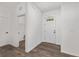Clean, neutral entryway featuring hardwood floors, seamlessly connecting to a convenient laundry area at 10347 Sw 99Th Ln, Ocala, FL 34481