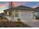 Charming home with an attached garage, verdant lawn, and manicured landscaping at 10347 Sw 99Th Ln, Ocala, FL 34481