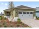 Charming home with an attached garage, verdant lawn, and manicured landscaping at 10347 Sw 99Th Ln, Ocala, FL 34481