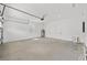 Spacious garage with high ceilings, a window, and white painted walls at 10347 Sw 99Th Ln, Ocala, FL 34481