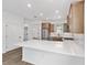 Bright kitchen boasts stainless steel appliances, wood cabinets, and a large quartz countertop island at 10347 Sw 99Th Ln, Ocala, FL 34481