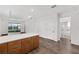 Kitchen island overlooks a screened-in porch, with wood cabinets and modern finishes at 10347 Sw 99Th Ln, Ocala, FL 34481