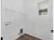 A laundry room with a wire shelf and white walls at 10347 Sw 99Th Ln, Ocala, FL 34481