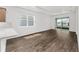 Bright living room area with new flooring, connecting to the screened porch at 10347 Sw 99Th Ln, Ocala, FL 34481