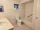 Well-lit bathroom featuring a tiled shower/tub, a white toilet, and a large white sink at 11025 Sw 64Th Ave, Ocala, FL 34476
