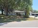 Quaint single-story home with mature trees in the front yard offers a cozy curb appeal at 11025 Sw 64Th Ave, Ocala, FL 34476