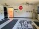 Spacious garage with painted floor, two ceiling fans, and access to the laundry room at 11025 Sw 64Th Ave, Ocala, FL 34476
