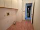 Functional laundry room with pink tile flooring and washer/dryer hookups at 11025 Sw 64Th Ave, Ocala, FL 34476
