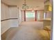 Open concept with kitchen, dining, and living area with neutral carpet and outdated decor at 11025 Sw 64Th Ave, Ocala, FL 34476