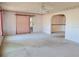 Large neutral carpeted living room with ceiling fan and sliding glass doors to porch at 11025 Sw 64Th Ave, Ocala, FL 34476