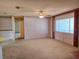 Neutral carpeted living room with a view of the outside through a large window at 11025 Sw 64Th Ave, Ocala, FL 34476