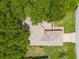 Aerial shot of a home showing the roof and brick driveway surrounded by lush trees at 11146 Sw 68Th Ct, Ocala, FL 34476