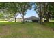 The backyard features lush green grass and mature trees at 11146 Sw 68Th Ct, Ocala, FL 34476
