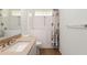 Bright bathroom featuring walk-in tub, decorative shower curtain, and granite-topped vanity at 11146 Sw 68Th Ct, Ocala, FL 34476