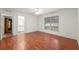 Bright bedroom featuring wood floors, a ceiling fan, and access to the bathroom and walk-in closet at 11146 Sw 68Th Ct, Ocala, FL 34476