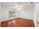 Bright bedroom with wood floors, bright window, and ceiling fan at 11146 Sw 68Th Ct, Ocala, FL 34476