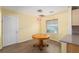 Cozy dining area with hardwood floors, pendant lighting and a view of the front yard at 11146 Sw 68Th Ct, Ocala, FL 34476
