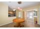 Open-concept dining area with a view of the kitchen and a bright sunroom, ideal for entertaining at 11146 Sw 68Th Ct, Ocala, FL 34476