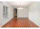 Dining room with wood floors, bright window, and ornate chandelier at 11146 Sw 68Th Ct, Ocala, FL 34476
