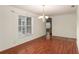 Dining room with wood floors, bright window, and ornate chandelier at 11146 Sw 68Th Ct, Ocala, FL 34476