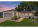 Charming home with brick paved driveway, lush lawn, and manicured landscaping at 11146 Sw 68Th Ct, Ocala, FL 34476