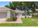 Charming home with brick paved driveway, lush lawn, and manicured landscaping at 11146 Sw 68Th Ct, Ocala, FL 34476