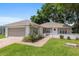 Charming home with brick paved driveway, lush lawn, and manicured landscaping at 11146 Sw 68Th Ct, Ocala, FL 34476