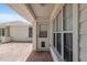 Covered front porch with brick pavers and a white front door at 11146 Sw 68Th Ct, Ocala, FL 34476