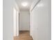 Bright hallway with multiple doorways, featuring wood floors, closet, and neutral paint at 11146 Sw 68Th Ct, Ocala, FL 34476