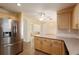 Spacious kitchen connected to the dining area with stainless steel appliances and light wood cabinets at 11146 Sw 68Th Ct, Ocala, FL 34476