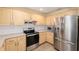 Modern kitchen features stainless steel appliances, light wood cabinets and a white tile backsplash at 11146 Sw 68Th Ct, Ocala, FL 34476