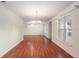 Large living room featuring wood floors, bright windows, and hanging chandelier at 11146 Sw 68Th Ct, Ocala, FL 34476