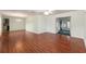 Bright living room featuring a ceiling fan, chandelier, and hardwood flooring at 11146 Sw 68Th Ct, Ocala, FL 34476