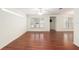 Spacious living room with sleek wood floors, bright windows, and ceiling fan at 11146 Sw 68Th Ct, Ocala, FL 34476