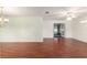 Open-concept living room features hardwood floors and ample natural light from the adjacent room at 11146 Sw 68Th Ct, Ocala, FL 34476
