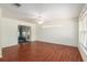 Spacious living room with hardwood floors, a ceiling fan and natural light from the windows at 11146 Sw 68Th Ct, Ocala, FL 34476