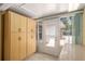 Enclosed sunroom with tile flooring, built in storage, and outdoor access at 11146 Sw 68Th Ct, Ocala, FL 34476
