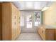 Bright sunroom features large storage cabinets, tile flooring, and plenty of natural light at 11146 Sw 68Th Ct, Ocala, FL 34476