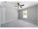 A neutral bedroom with a ceiling fan fixture and natural light from the adjacent window at 12720 Sw 73Rd Street, Ocala, FL 34481