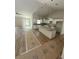 Spacious kitchen with white cabinets, granite countertops, and center island before completion at 12720 Sw 73Rd Street, Ocala, FL 34481