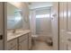 Bathroom featuring a tiled tub/shower combo, single sink vanity, and a small window at 15691 Sw 11Th Court Rd, Ocala, FL 34473
