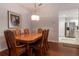 Formal dining area with hardwood floors, a large table, and decorative lighting at 15691 Sw 11Th Court Rd, Ocala, FL 34473