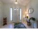 Inviting foyer with neutral tile flooring, decorative mirror, and elegant chandelier at 15691 Sw 11Th Court Rd, Ocala, FL 34473