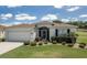 Charming single-story home with a well-manicured lawn and an attached two-car garage at 15691 Sw 11Th Court Rd, Ocala, FL 34473