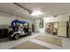 Well lit garage with storage and golf cart at 15691 Sw 11Th Court Rd, Ocala, FL 34473