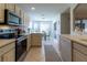 Bright kitchen with white cabinets, modern appliances, and a view of the breakfast nook at 15691 Sw 11Th Court Rd, Ocala, FL 34473