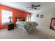 Comfortable main bedroom with a vibrant accent wall, ceiling fan, and natural light at 15691 Sw 11Th Court Rd, Ocala, FL 34473