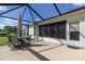 Outdoor patio space with table, chairs, and overhead screen at 15691 Sw 11Th Court Rd, Ocala, FL 34473